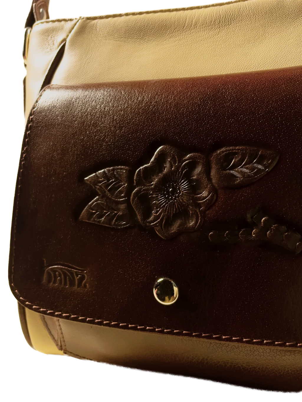 Kanz Lu'lu hand-tooled leather crossbody bag in sand with a brown flap, close-up of the carved flower, handmade in Cairo