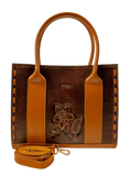 Kanz Naqsh hand-carved leather handbag in brown with cognac handles, front view with the detachable strap, handmade in Cairo